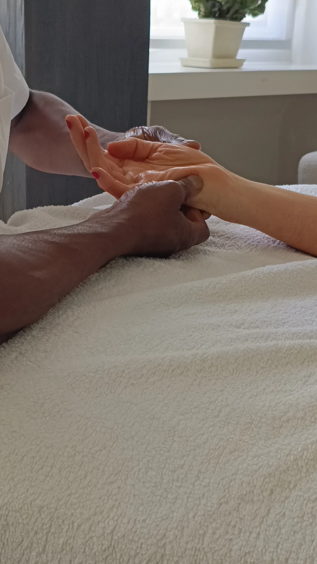 Gentle hand reflexology during a session at Vibelle Therapy