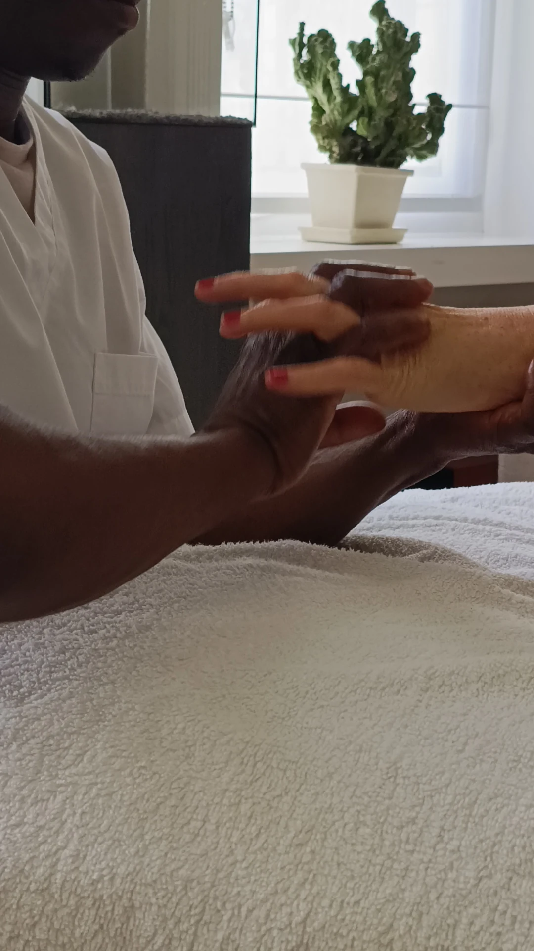 Close-up of a gentle hand reflexology treatment